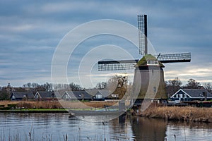 Historical dutch windmill along the canal in Alkmaar, Province North Holland