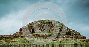 Historical fortification of the Sardinia region, the nuraghe was the residence of the chief tribes maquis in bloom in spring photo