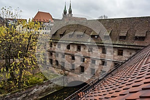 Historical Heilig-Geist-Spital Holy Spirit Hospital near Pegnitz river in the old town of Nuremberg, Bavaria, Germany