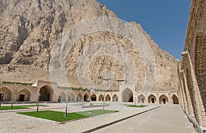 Historical hotel courtyard past mountain in Iran. Caravanserai structure