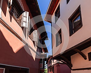 Historical narrow streets of Plovdiv, heaped houses of different architectural styles violate urban planning conceivable rules