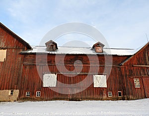 Historical NYS antique red barn with barn roof additions