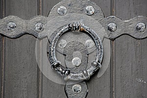 Historical old antique door handle close-up of a castle wooden door background texture