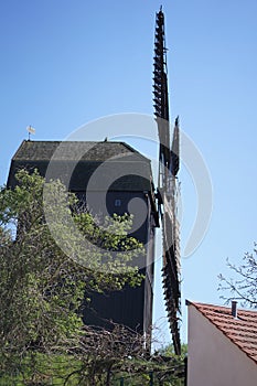 Historical wooden windmill against blue sky in Werder, Brandenburg, Germany photo