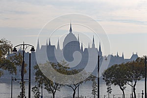Historical Parliament building next to the river Danube on a foggy day in Budapest capital city of Hungary color photo.