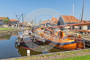 Historical fishing vessels anchored in harbor Dutch fishing village Workum