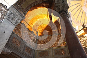 Hagia sophia mosque inside. Ancient illuminations lamps and yellow mosaic. Architectural details of dome and ancient windows photo
