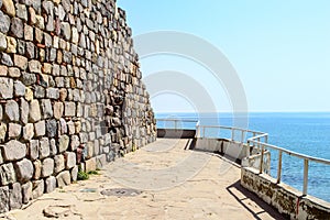 Historical southern walls over the BLack sea cove in Sozopol, Bulgaria, Europe at dusk.