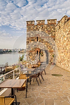 Historical southern walls and tower gate over the Black sea cove in Sozopol, Bulgaria, Europe at dusk.