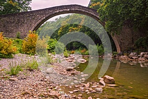 The historical stone bridge of Pyli and Portaikos river located in short distance from Trikala and the village of Pyli