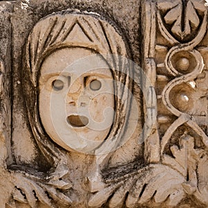 Historical Stone faces bas relief and ancient theater at Myra ancient city. Demre, Antalya, Turkey.