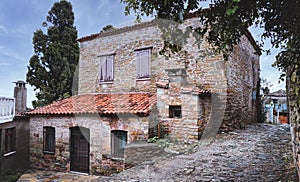 A historical stone house and narrow stone pathways in ZeytinlikÃ¶y, GÃ¶kÃ§eada.