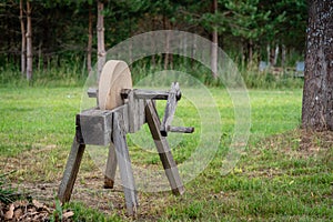 Historical tools. An old, hand-operated, sharpening tool - a grindstone. photo