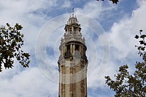 A historical tower on a blue sky with delicate clouds. photo