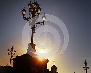 Historical traditional street lights and sun rays at sunset, details of architecture and history in Moscow, the capital of Russia