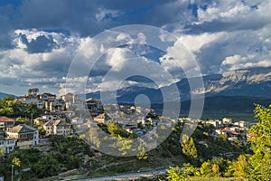 Historical UNESCO protected town of Gjirocaster , Southern Albania on background of Balkan mountains and dramatic cloudy sky. Hous