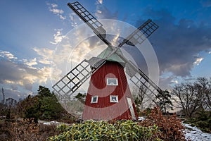 historical windmill made of red wood in a winter landscape.Stenungsund in Sweden photo