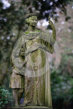 Historical woman figure with child in an old cemetery