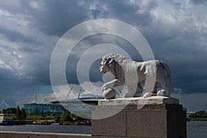 History and modernity - a white lion statue and a modern stadium that looks like a flying saucer. St. Petersburg