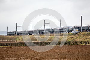 Hitachi Train passing partially completed electrification