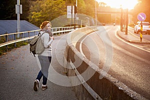 Hitch-hiking girl on a road