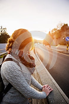 Hitch-hiking girl on a road