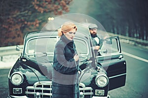 Hitch hiking on road with luxury people. hitch hiking of retro car by woman and bearded man.