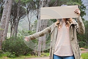 Hitch hiking woman holding cardboard