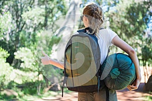 Hitch hiking woman with sleeping bag