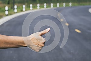 Hitchhiker sign thumb up on Highway road Outdoor photo