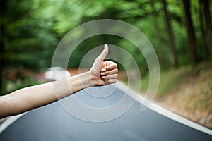 Hitchhikers female hand stopping the car