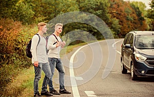 Hitchhiking gesture. Begin great adventure in your life with hitchhiking. Company friends travelers hitchhiking at road