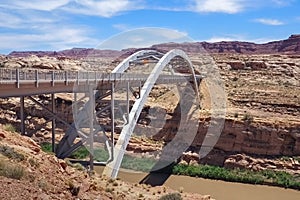 Hite crossing steel bridge across canyon of Colorado River in Utah, USA. Classic arch of a bridge in the American desert