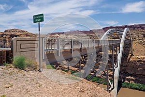 Hite crossing steel bridge across canyon of Colorado River in Utah, USA. Classic arch of a bridge in the American desert