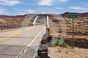 Hite crossing steel bridge across canyon of Colorado River in Utah, USA. Classic arch of a bridge in the American desert