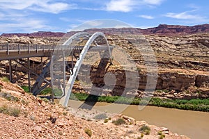 Hite crossing steel bridge across canyon of Colorado River in Utah, USA. Classic arch of a bridge in the American desert