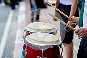 Hitting an African drums. Play on a musical instrument Drummer. Drum sticks hitting the drum.