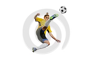Hitting ball in a jump. Young professional female football, soccer player in motion, training, playing isolated over