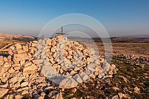 Hlam - Summit cross on massive rock pile of mountain top Hlam in Baska, Krk Island, Primorje-Gorski Kotar