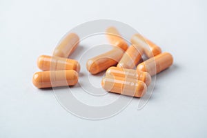 HMB Î²-Hydroxy Î²-methylbutyric acid capsules. Bodybuilding food supplements on bright paper background.