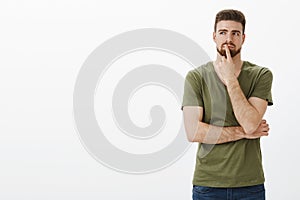 Hmm it might work. Portrait of man making plan and taking decision in mind standing in thoughtful pose touching lip with