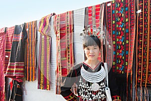 Hmong girl on their traditional dress is selling Hmong garments and scarf