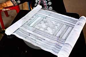 hmong woman drawing the patterns for beautiful handmade fabrics of hill tribe people of Thailand