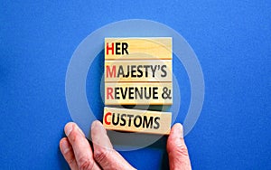 HMRC her majestys revenue and customs symbol. Concept words HMRC her majestys revenue and customs on blocks on beautiful blue