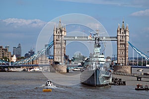 HMS Belfast moored in front of Tower Bridge on the River Thames. London, UK.