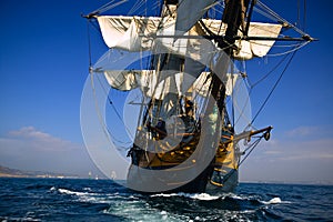 HMS Surprise sailing at sea under full sail