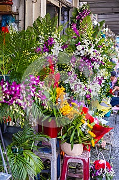 Ho Chi Minh City, Vietnam - November 10, 2022: Flower store on the sidewalk in the streets of Saigon. Vendor with small shop