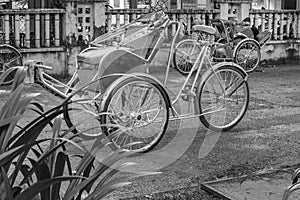 Ho Chi Minh City, Vietnam - September 1, 2018: Vietnamese cyclos and the shape of an undefined man in the back taking a break whil