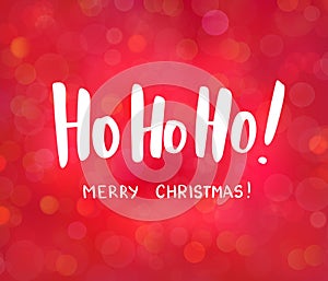 Ho-ho-ho and Merry Christmas text, hand drawn lettering. Blurred background with bokeh effect. Great for Christmas, New
