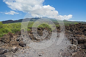 Hoapili trail through lava field and mountain landscape
